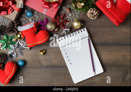 New year resolutions text on note paper with decorations and gift boxes, New year and Merry christmas goal  conceptual Stock Photo