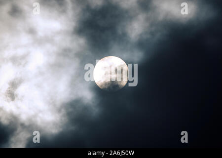 Bright sun behind stormy clouds Stock Photo