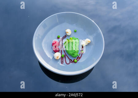 Pea and mint sorbet with raspberries and popcorn. View from above Stock Photo