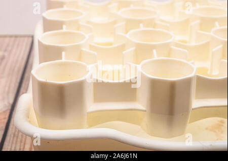 White plastic drying rack for the bottles on the wooden table Stock Photo