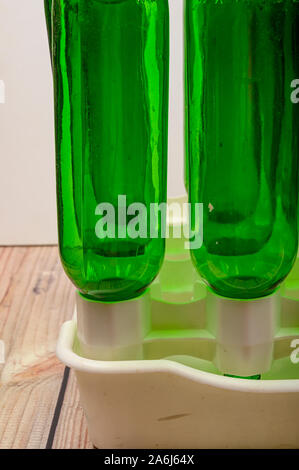 Empty wine bottles in a plastic dryer on the table Stock Photo