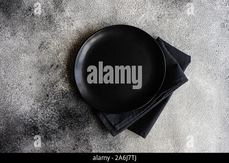 Cutlery set with empty plates on stone background with copy space Stock Photo