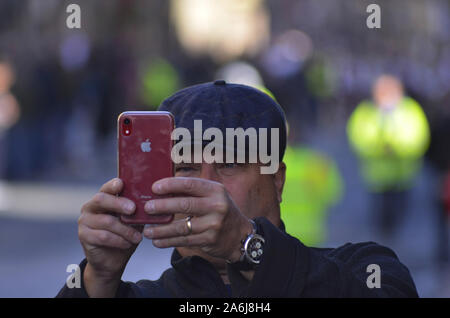 Man takes photos with an iPhone during the 2019 Riding of the Marches in Edinburgh Scotland UK. Over 250 horses and riders took part in the event. Stock Photo