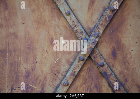 Grunge metal with rivets background. Metal surface of vintage door Stock Photo