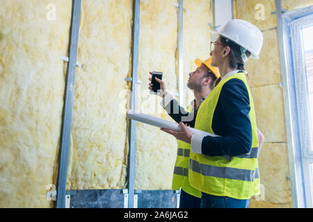 Construction manager and architect checking the insulation works Stock Photo