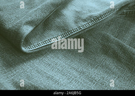 Folded purist blue jeans abstract background. Selective focus Stock Photo