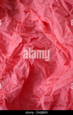 Scarlet crumpled paper flat lay. Crepe paper background. Stock Photo