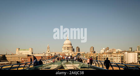 LONDON, UK, February 26, 2019: Pedestrians are walking over Millenium Bridge, St. Paul' s Cathedral beyond