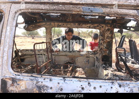 Barisha, Syria. 27th Oct, 2019. Syrian children inspect a burnt vehicle at the site near the northwestern Syrian village of Barisha in the province of Idlib near the border with Turkey, after media reports said Islamic State (IS) leader Abu Bakr al-Baghdadi was believed to be killed in a US Special Forces raid in the same province. Credit: Mustafa Dahnon/dpa/Alamy Live News Stock Photo