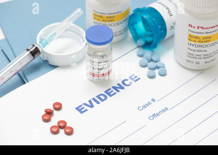 Various drugs and paraphanalia with law enforcement evidence documentmentation. Stock Photo