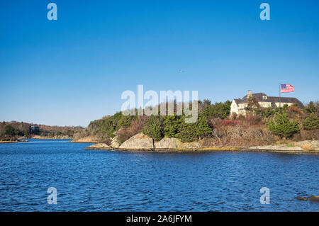 Large homes lining the goose neck salt marsh in Newport Rhode Island on a sunny blue sky autumn day. Stock Photo