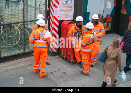 looking down at 5 workmen in high vis safety wear Stock Photo