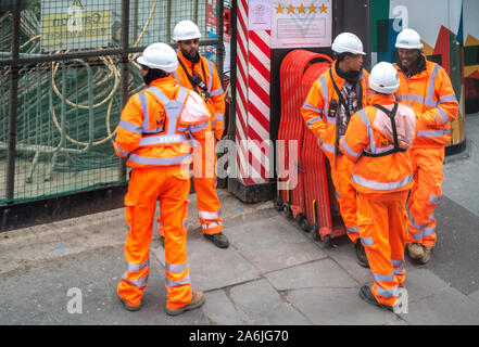 looking down at 5 workmen in high vis safety wear Stock Photo