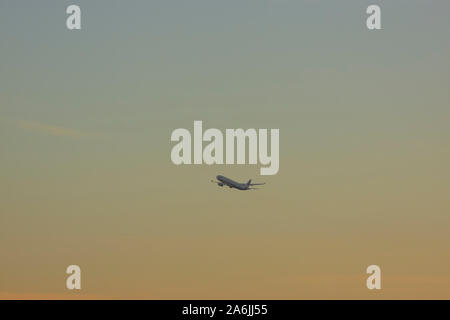 Airplane taking off in sunset Stock Photo