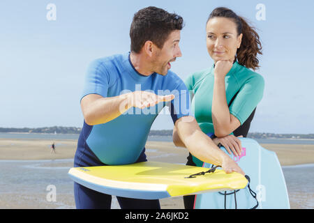 she is learning to surf Stock Photo