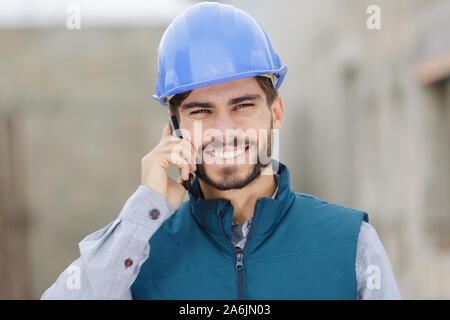 happy young engineer using mobile phone Stock Photo