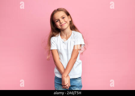 nice lovely girl in white T-shirt and jeans with chrarming smile holding her arms together. close up photo. Stock Photo