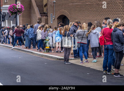 upper middle class Americans waiting in line for an hour to buy overpriced cupcake at an upscale luxury bakery in Georgetown Stock Photo