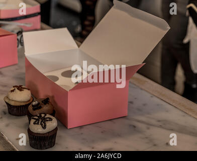 Gourmet cupcakes with a pink box in Gerogetown Stock Photo