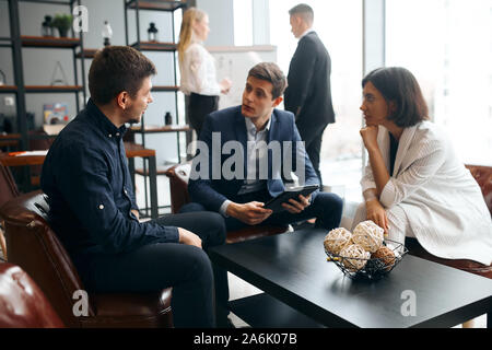 young creative designers discussing new interier. close up photo.young people developing plan of reconstruction of building Stock Photo