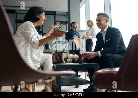 young businessman and businesswoman having fun during the conversation. close up side view photo Stock Photo