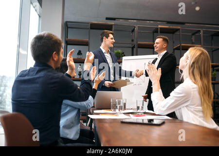 handsome boss welcoming, greeting new employee, two companies have agreement, support concept, partnership, friendship, teamwork Stock Photo