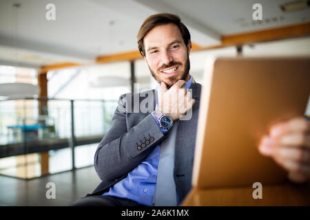 Elegant business multitasking multimedia man using devices Stock Photo