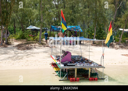 Mauritius beach stall; a boat stall selling crafts on the beach at Ile aux Benitiers, Le Morne, Mauritius