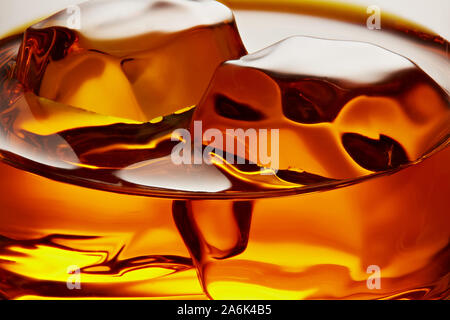 Glass of elegant whiskey with ice cubes. Macro closeup view Stock Photo