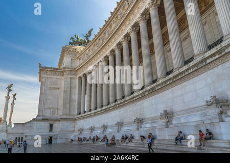 Tourists sitting on the stairs near the National Monument of Victor Emmanuel II in Rome, Italy. Altar of the Fatherland Stock Photo