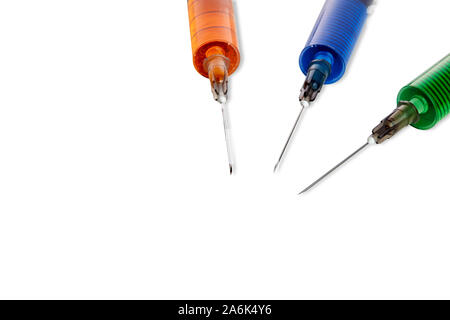 Three syringes filled with colorful liquids against white background Stock Photo