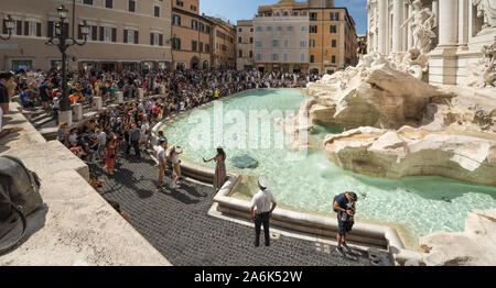A lot of tourists near famous Trevi fountain in Rome, Italy. Crowds of people are making pictures and selfies in front of fountain di Trevi Stock Photo