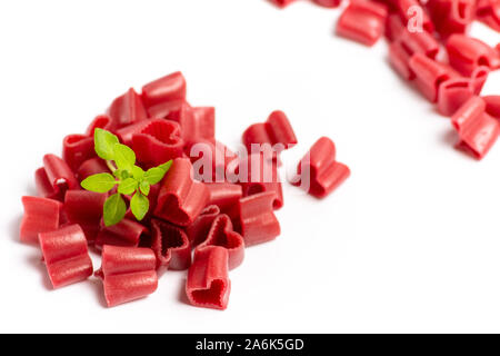 Colorful heart shape macaroni pasta on white background Stock Photo