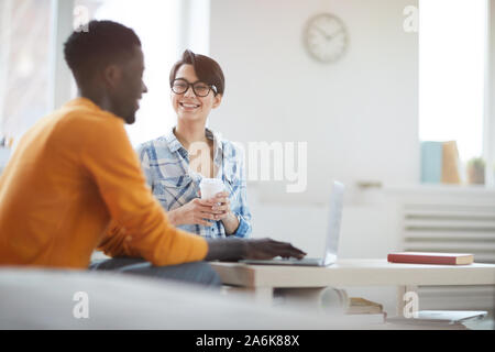 Portrait of two young entrepreneurs smiling happily while discussing new business in office, copy space Stock Photo