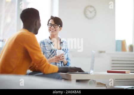 Portrait of two young entrepreneurs smiling happily while discussing startup project in office, copy space Stock Photo