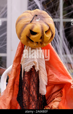 Pumpkin head scarecrow decorating home exterior in Halloween season Stock Photo