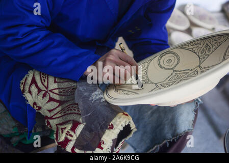 Detail of Man Hand-painting Pottery Stock Photo