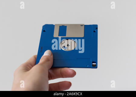 Holding Blue Floppy A disks isolated on white background.Disk storage Stock Photo