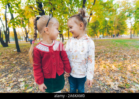 two girls playing at autumn city park Stock Photo