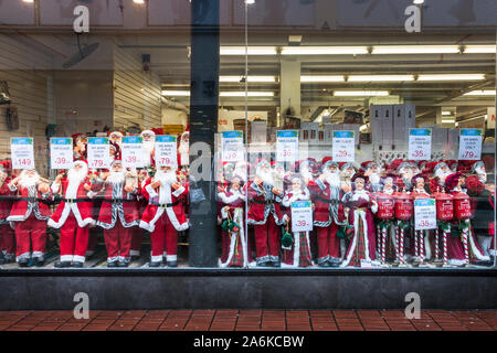 Cork City, Cork, Ireland. 25th October, 2019. Department Store window filled with Santa Claus dolls in Oliver Plunkett Street, Cork, Ireland. - Credit Stock Photo