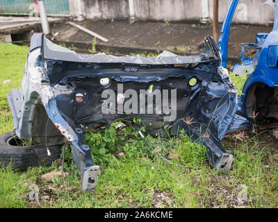 Old rusty half cut car by the road side after the accident at the workshop Stock Photo