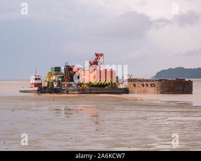 Sand barge in the middle of the sea Stock Photo