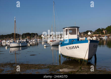 Village of Plouhmanac’h, France. Picturesque morning view of a fishing vessel anchored on boat legs at Port de Ploumanac'h. Stock Photo