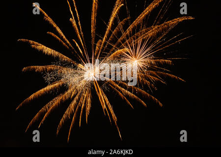Couple of awesome golden fireworks against the backdrop of the night sky Stock Photo