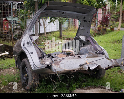 Old rusty half cut car by the road side after the accident at the workshop Stock Photo