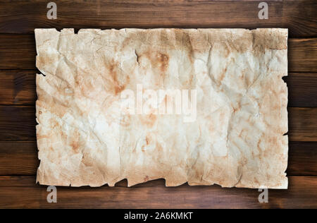 Old grunge paper template for announcement on dark brown wall wooden texture Stock Photo