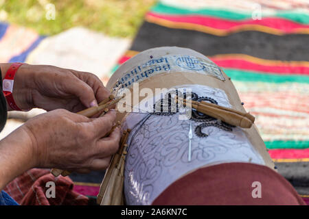 Old knitting technique with wooden sticks and hooks on a template Stock Photo