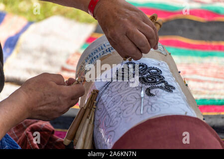 Old knitting technique with wooden sticks and hooks on a template Stock Photo