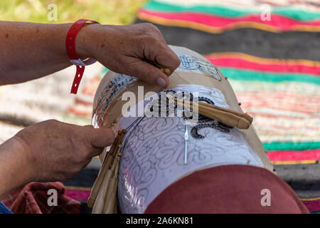 Old knitting technique with wooden sticks and hooks on a template Stock Photo