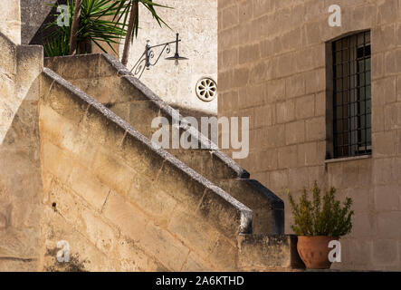 Staircase with pot of folwers at ancient town of Matera